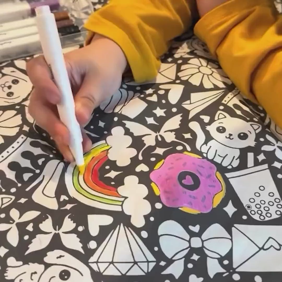 The Coloring Blanket in action: unboxing, colouring the design with the fabric markers, and the finished blanket on the sofa
